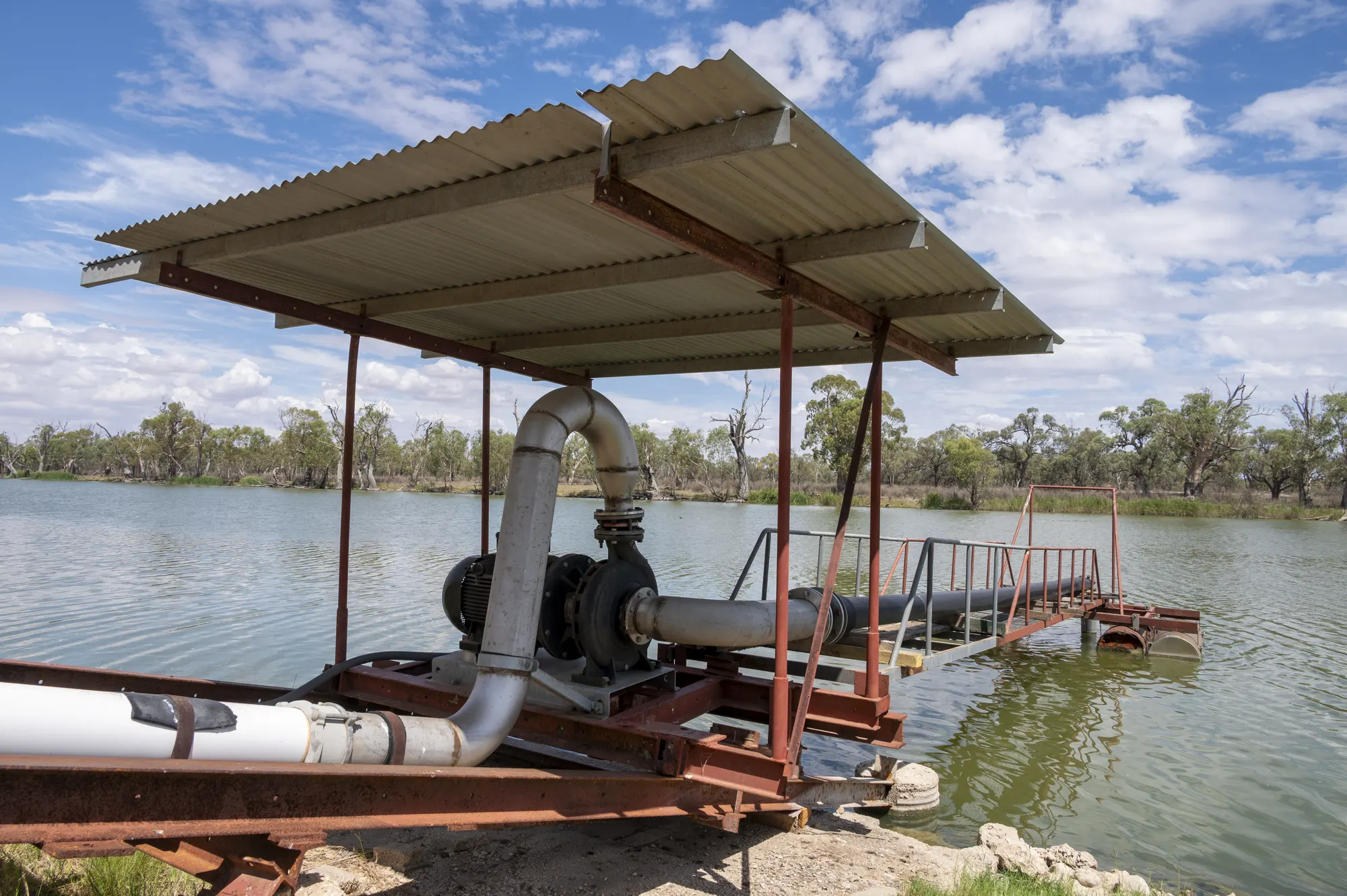 Pump and pipework mounted under a shade roof beside Big Toolunka Creek