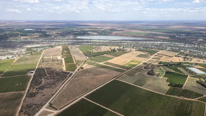Expansive aerial of the surrounding irrigated horticultural district
